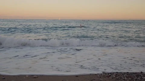 Waves rolling onto shore at beach Stock Footage 283593357