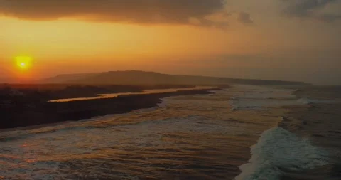 Waves Rolling Onto Shore During Sunrise Golden Hour 스톡 동영상 332144629