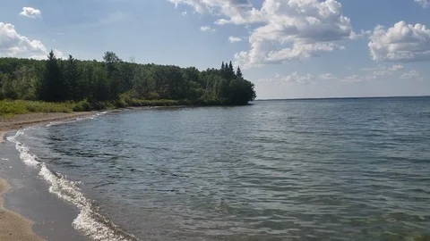 Waves rolling into the shoreline at Clear Lake, Manitba Stock Footage 105802974