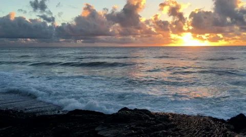Waves rolling in at sunrise, black sand and cliffs in foreground (4K) Stock Footage 61175962