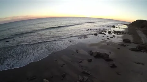 Waves rolling onto sunset horizon Stock Footage 58020950