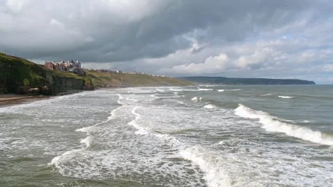 Waves rolling in to Whitby beach, North Yorkshire at high tide (slow motion) Stock-Footage 287751886