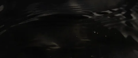 The waves run over the dark texture of the underlying water in slow motion Stock Footage 106002574