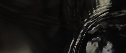 The waves run over the dark texture of the underlying water in slow motion Stock Footage 106002586