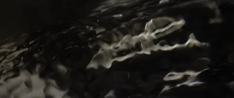 The waves run over the dark texture of the underlying water in slow motion Stock Footage 106002682