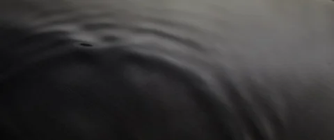 The waves run over the dark texture of the underlying water in slow motion Stock Footage 106002712