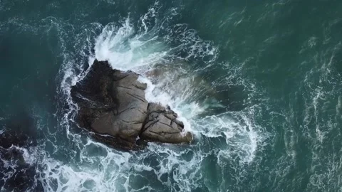 Waves run over a stone, view from a drone, reverse video Stock Footage 164921091