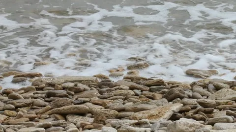 Waves run onto the shore with pebbles. Stock Footage