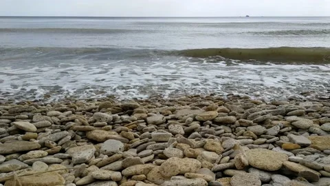 Waves run onto the shore with pebbles. Stock Footage 153557770