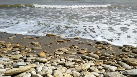 Waves run onto the shore with pebbles. Stock-Footage 153616938
