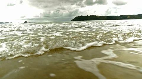 Waves rushing in on a beach Stock Footage 48060696
