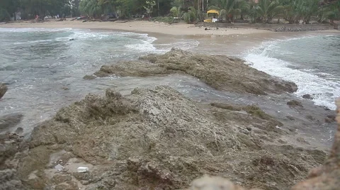 Waves rushing through &amp; over a seawall Stock Footage 65330193