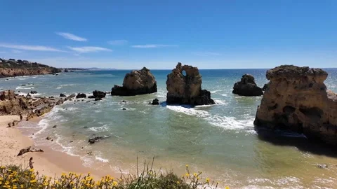 Waves, Sand and Rugged Rocks at the Quiet Coast of Praia dos Arrifes, Algarve Stock Footage 335048007
