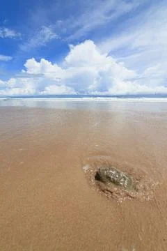 Waves sand beach and clouds sunny day Stock Photos