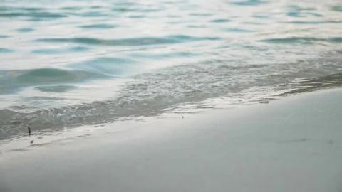Waves at sand beach with footsteps Stock Footage 131347860