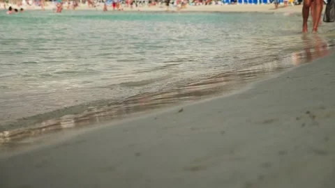 Waves at sand beach with footsteps Stock Footage 131348257