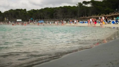 Waves at sand beach with footsteps Stock Footage 131349517