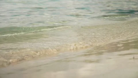 Waves at sand beach with footsteps Stock Footage 131349676