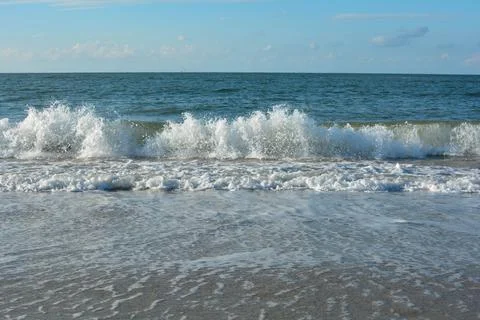 Waves on sand beach with  sky Stock Photos