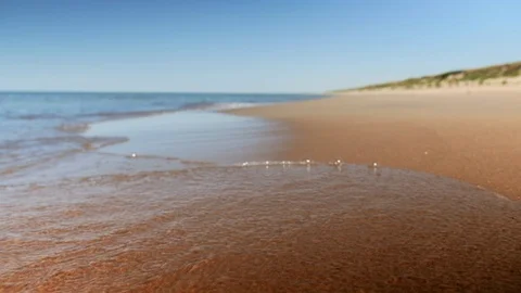 Waves on the sand beach slowmotion Stock Footage 83436237