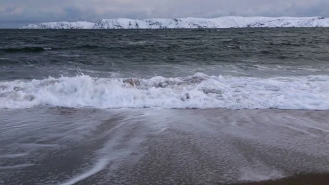 Waves on a sand coast of the Barents Sea at sunset. Arctic landscape Stock Footage 103545699
