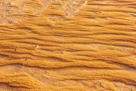 Waves on the sand on a sandy beach. Stock Photos