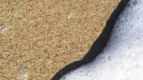 Waves in the sand in slowmotion (vertical video) Stock Footage 96323639