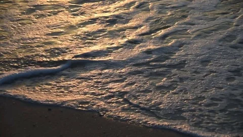 Waves on the sand at sunset Video stock 82533736