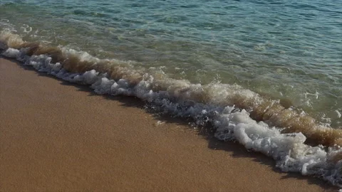 Waves on the sand wash the shore. surf sunset Stock Footage 221348564