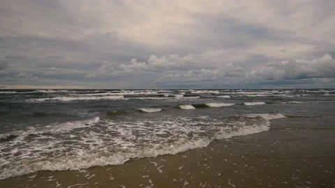 Waves on a sandy Baltic beach in a storm. Clouds over the horizon at the end Stock Footage 160958858