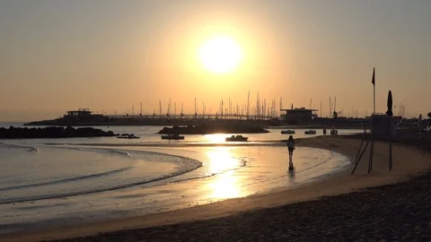 Waves on Sandy Beach Background at Sunrise or Sunset with Harbour 스톡 동영상 120942059