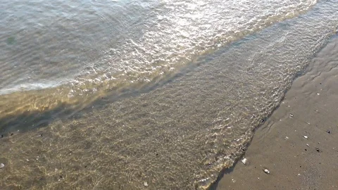 Waves on Sandy Beach Background at Sunrise or Sunset Stock Footage 120942060