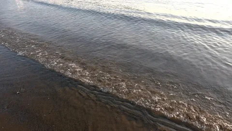 Waves on Sandy Beach Background at Sunrise or Sunset Stock Footage 120942136