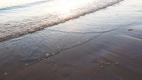 Waves on Sandy Beach Background at Sunrise or Sunset Stock Footage 120942152