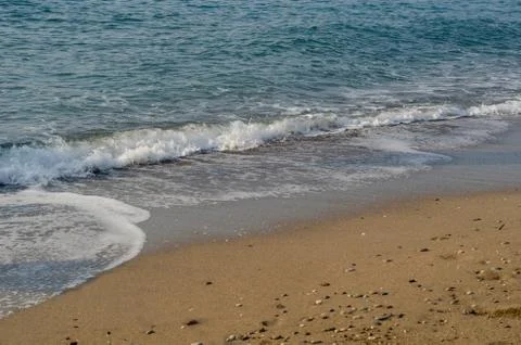 Waves on a sandy beach.  Background for web pages and printing. Stock Photos
