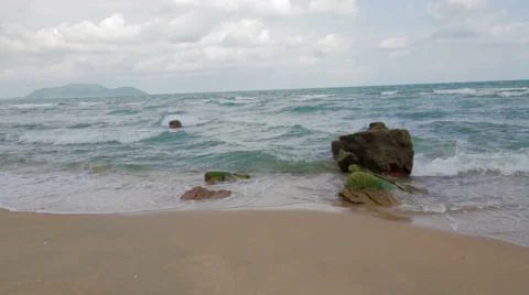 Waves on a Sandy Beach with Big Rock Stock Footage 66065147