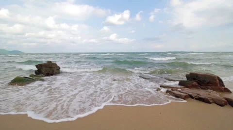 Waves on a Sandy Beach with Big Rocks Stock Footage 66065216