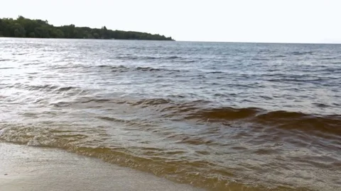 Waves on a sandy beach Stock Footage 76940651
