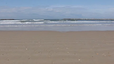 Waves on a sandy beach Stock Footage 125403285