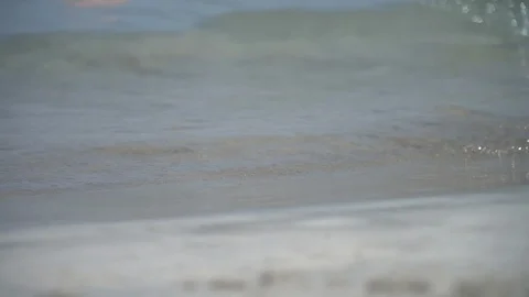 Waves on sandy beach Stock Footage 128349626