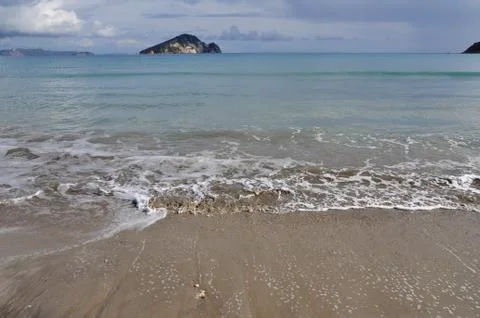 Waves on sandy beach Stock Photos