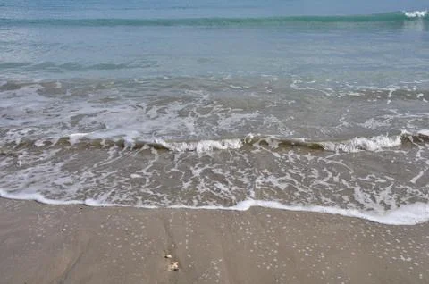 Waves sandy beach Stock Photos