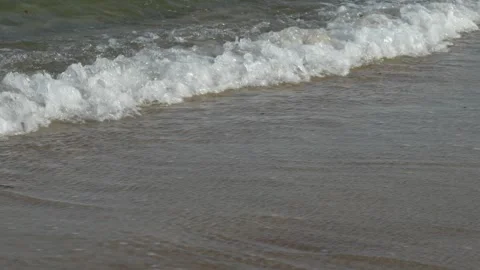 Waves at a sandy beach in summer, no color grading, slowmotion Stock Footage 286061480