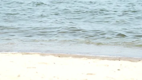 Waves at a sandy beach in summer, no color grading, slowmotion Stock Footage 286061583