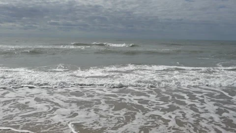 Waves at a sandy beach in summer, no color grading, slowmotion Stock Footage 286061915