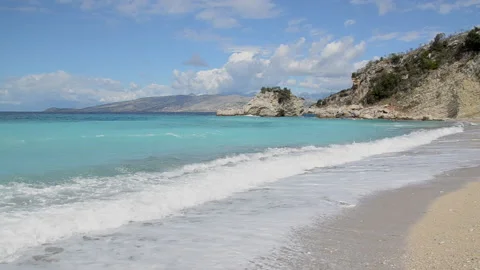 Waves on sandy beach at summer. Turquoise color of water. Sarande, Albania Stock Footage 142845872