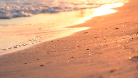 Waves on sandy beach at sunset Stock Footage 75156856