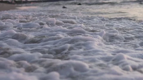 Waves on a sandy beach at sunset in the sea, slow-motion filming. Stock Footage 160115939