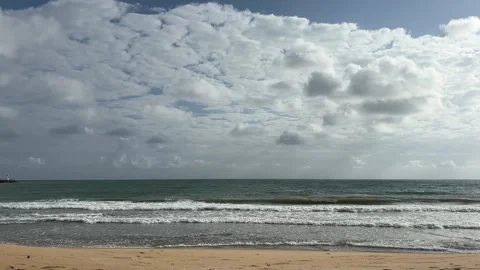 Waves on a sandy beach under cloudy sky, Kuala Terengganu Stock Footage 328489500