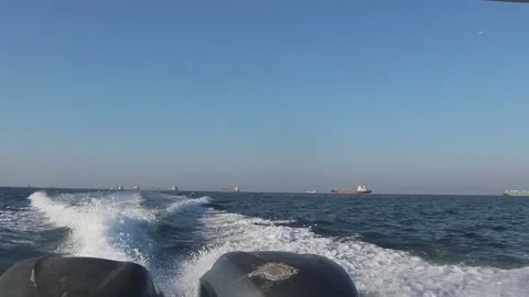 Waves in the sea that appear because of the speed boat engine Stock Footage 253538802